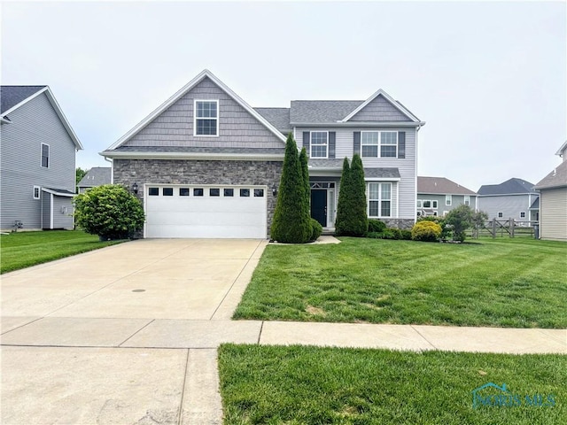 3244 Chasenwood Way, Perrysburg, OH 43551 - view of front of property with stone siding, concrete driveway, and a garage