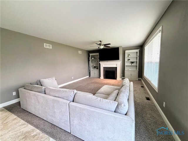 3244 Chasenwood Way, Perrysburg, OH 43551 - living area with ceiling fan, carpet flooring, baseboards, and a fireplace