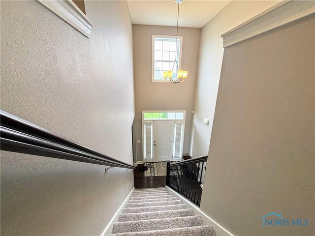 3244 Chasenwood Way, Perrysburg, OH 43551 - stairway featuring a chandelier and baseboards