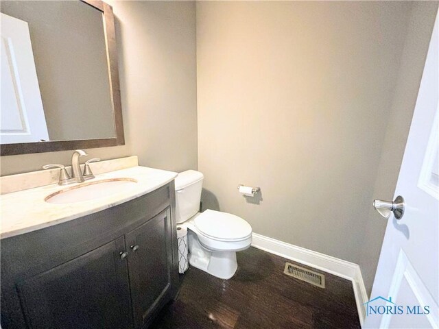 3244 Chasenwood Way, Perrysburg, OH 43551 - half bathroom featuring vanity, toilet, wood finished floors, and baseboards