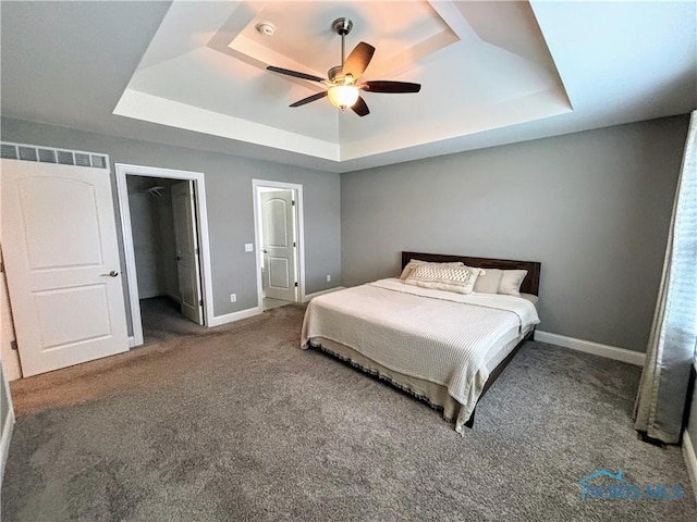 3244 Chasenwood Way, Perrysburg, OH 43551 - carpeted bedroom featuring a tray ceiling, baseboards, a walk in closet, and a ceiling fan