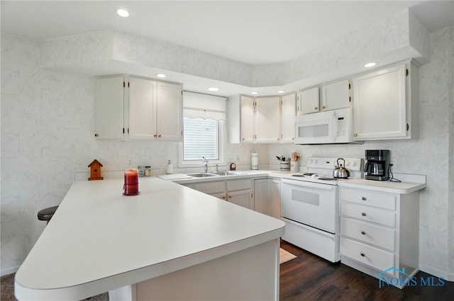 5733 Brook Cliffe Rd, Toledo, OH 43614 - kitchen with white appliances, a peninsula, a sink, dark wood-type flooring, and light countertops
