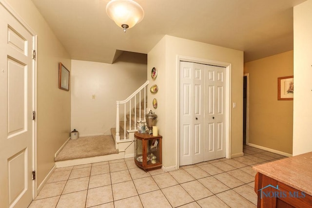 633 Hillcrest Ave, Findlay, OH 45840 - entrance foyer featuring light tile patterned flooring, stairway, and baseboards