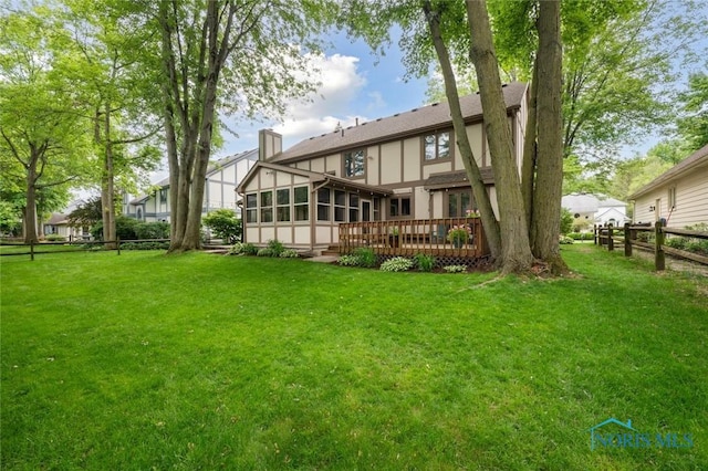 2426 Gibley Park Rd, Toledo, OH 43617 - back of property featuring a sunroom, a deck, a chimney, and stucco siding