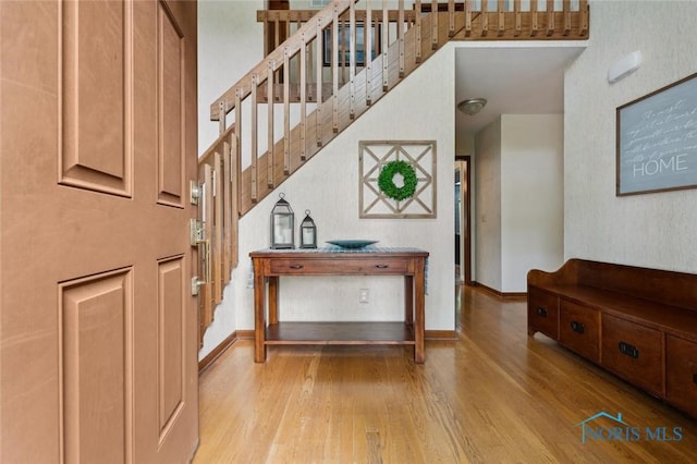 2426 Gibley Park Rd, Toledo, OH 43617 - entrance foyer with hardwood / wood-style floors, a high ceiling, and baseboards
