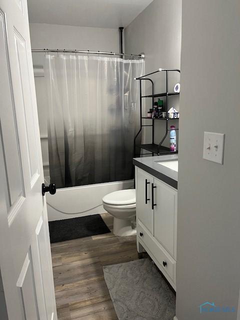 538 Frazer St, Findlay, OH 45840 - full bathroom featuring shower / bathtub combination with curtain, wood finished floors, vanity, and toilet