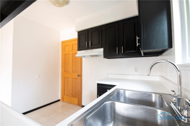 1621 Acorn Dr, Toledo, OH 43615 - kitchen with dark cabinetry, under cabinet range hood, and light countertops