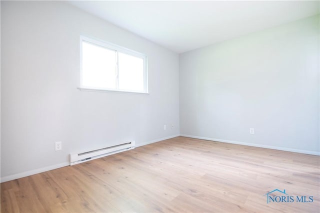 1621 Acorn Dr, Toledo, OH 43615 - empty room with baseboard heating and wood finished floors