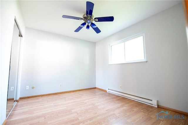 1621 Acorn Dr, Toledo, OH 43615 - unfurnished room with a baseboard heating unit, light wood finished floors, and ceiling fan