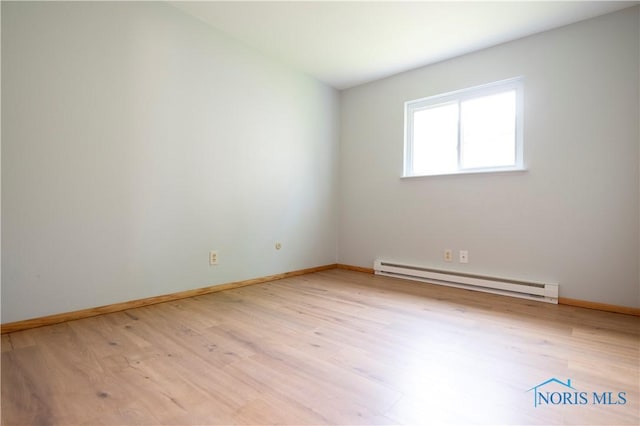 1621 Acorn Dr, Toledo, OH 43615 - unfurnished room with a baseboard radiator and light wood-style floors
