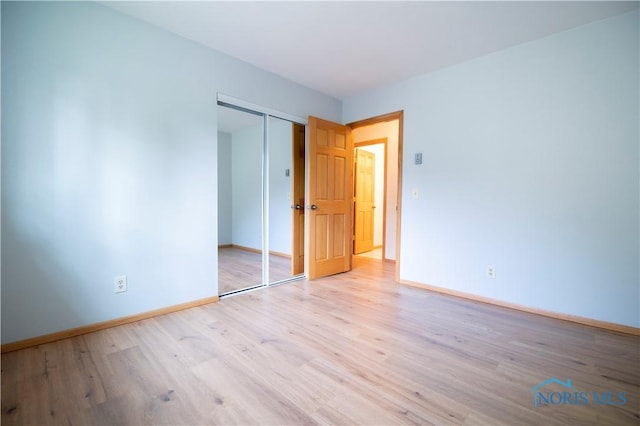 1621 Acorn Dr, Toledo, OH 43615 - unfurnished bedroom featuring wood finished floors and a closet