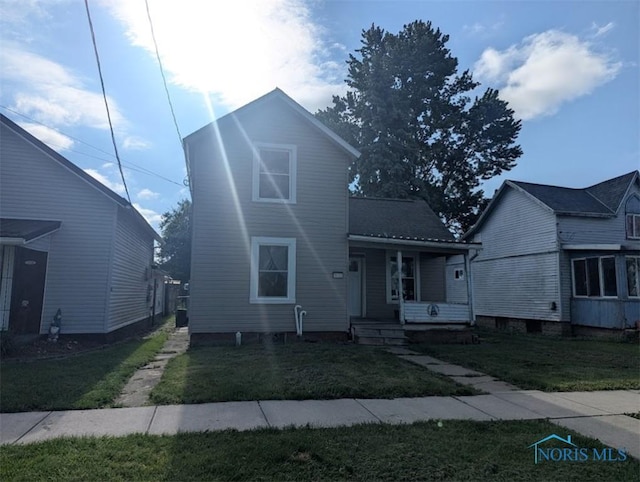 1022 Dodd St, Napoleon, OH 43545 - view of front of house with a porch and a front lawn