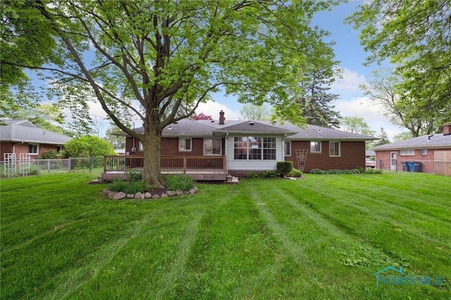 4801 Estero Pl, Toledo, OH 43623 - rear view of house featuring a wooden deck, brick siding, and a chimney