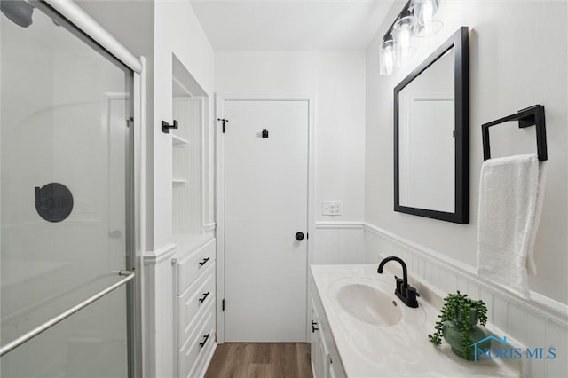 4801 Estero Pl, Toledo, OH 43623 - full bath with vanity, a stall shower, a wainscoted wall, and wood finished floors