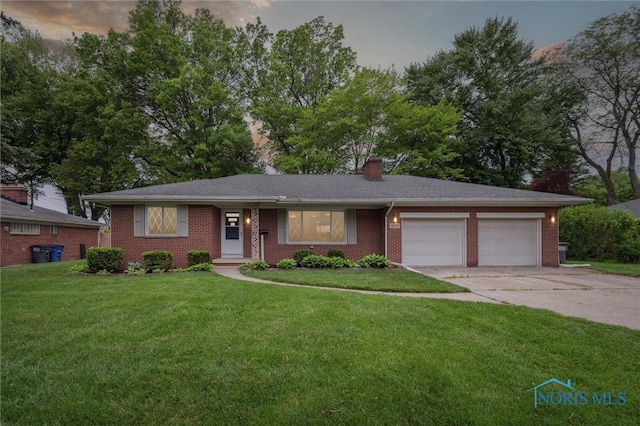 4801 Estero Pl, Toledo, OH 43623 - view of front of home with a garage, concrete driveway, a front lawn, brick siding, and a chimney