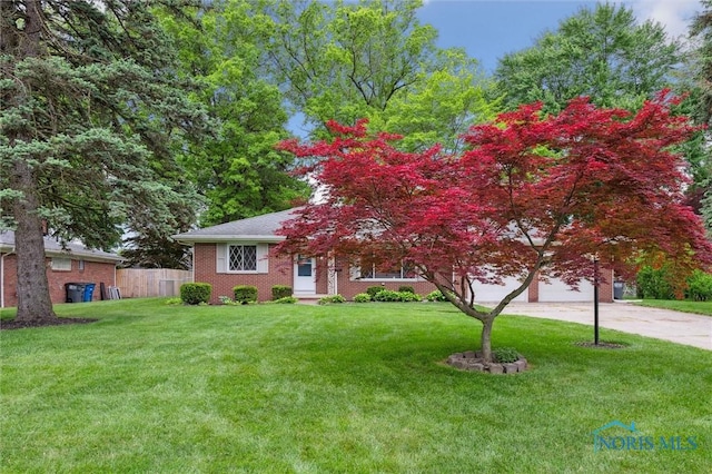 4801 Estero Pl, Toledo, OH 43623 - view of front of property featuring concrete driveway, brick siding, and an attached garage
