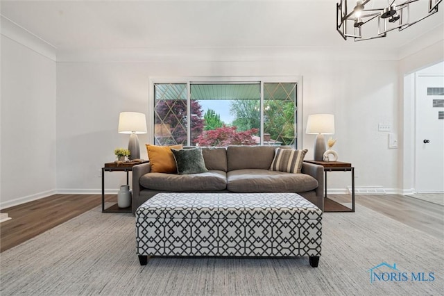 4801 Estero Pl, Toledo, OH 43623 - living area featuring a chandelier, baseboards, and wood finished floors