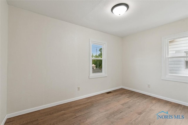 3409 Kirby Pl, Toledo, OH 43608 - spare room featuring wood finished floors and baseboards