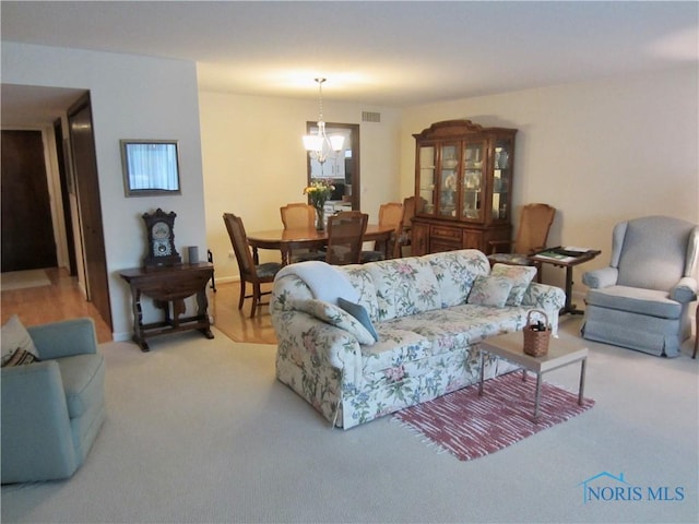 4343 W Bancroft St Unit 2D, Toledo, OH 43615 - living room with light carpet and a chandelier