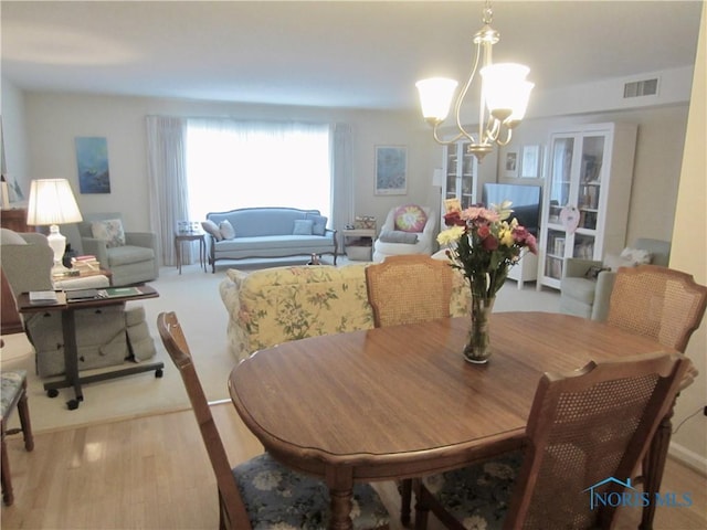 4343 W Bancroft St Unit 2D, Toledo, OH 43615 - dining space with a chandelier and light wood-type flooring
