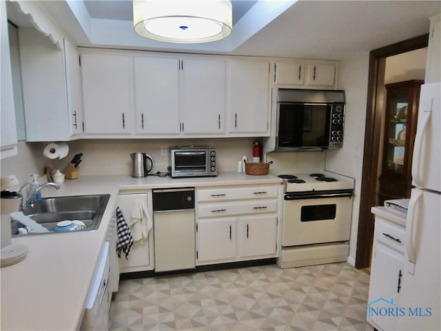 4343 W Bancroft St Unit 2D, Toledo, OH 43615 - kitchen featuring white appliances, light countertops, light flooring, a sink, and white cabinets