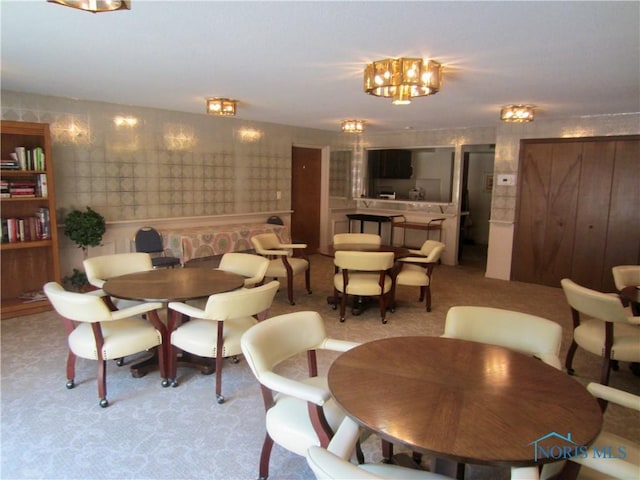 4343 W Bancroft St Unit 2D, Toledo, OH 43615 - dining area with light colored carpet and a chandelier