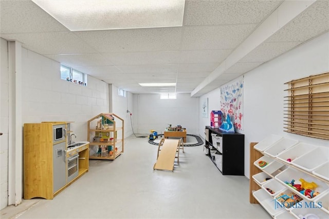 955 Westmont Ave, Napoleon, OH 43545 - rec room with finished concrete flooring and a paneled ceiling