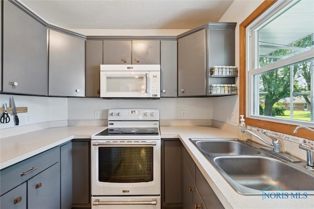 955 Westmont Ave, Napoleon, OH 43545 - kitchen with white appliances, gray cabinetry, and light countertops