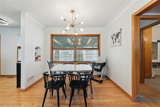 955 Westmont Ave, Napoleon, OH 43545 - dining space with a chandelier, light wood-style flooring, and crown molding