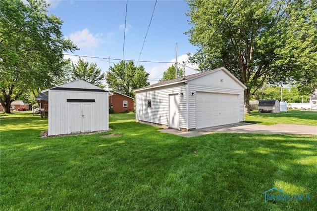 955 Westmont Ave, Napoleon, OH 43545 - view of grassy yard with an outbuilding and a detached garage