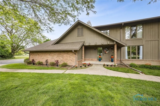 29674 E River Rd, Perrysburg, OH 43551 - mid-century modern home with brick siding, a front yard, and a chimney
