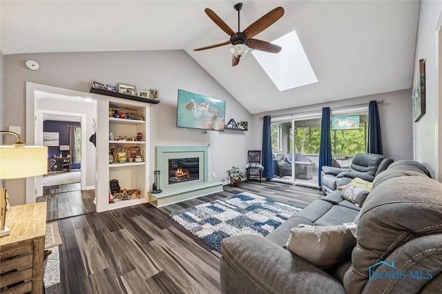 29674 E River Rd, Perrysburg, OH 43551 - living area with a ceiling fan, a skylight, dark wood-style floors, a glass covered fireplace, and high vaulted ceiling