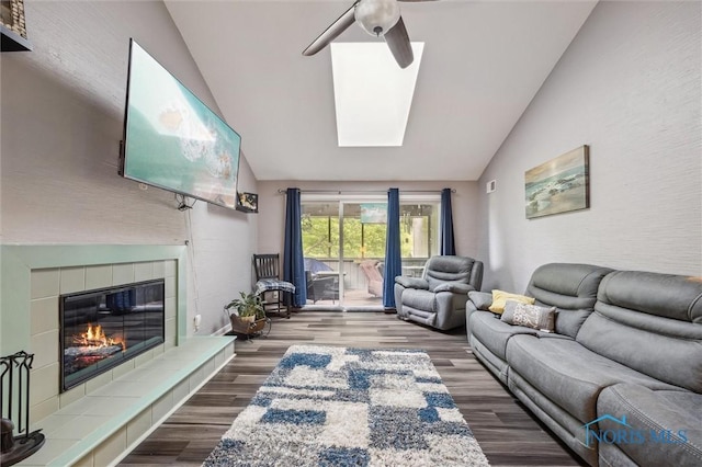 29674 E River Rd, Perrysburg, OH 43551 - living area featuring vaulted ceiling, a ceiling fan, wood finished floors, a fireplace, and a skylight