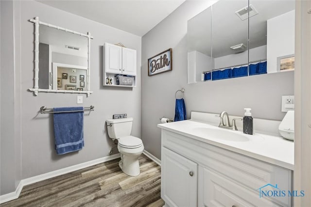 29674 E River Rd, Perrysburg, OH 43551 - bathroom featuring wood finished floors, baseboards, vanity, toilet, and a shower with curtain