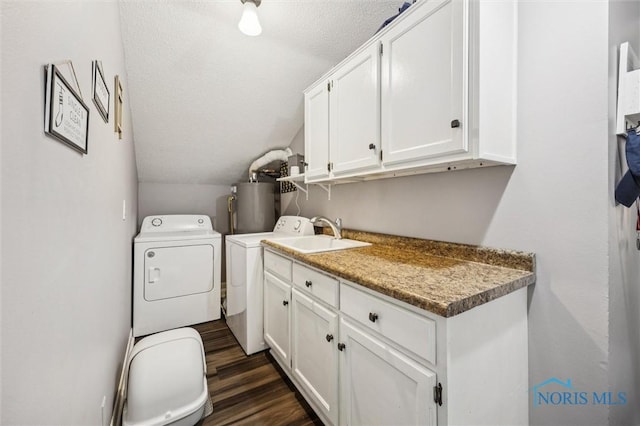 29674 E River Rd, Perrysburg, OH 43551 - washroom with washer and clothes dryer, water heater, dark wood-type flooring, a textured ceiling, and cabinet space