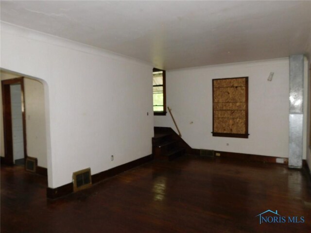1839 Talbot St, Toledo, OH 43613 - spare room with wood finished floors, crown molding, arched walkways, baseboards, and stairs