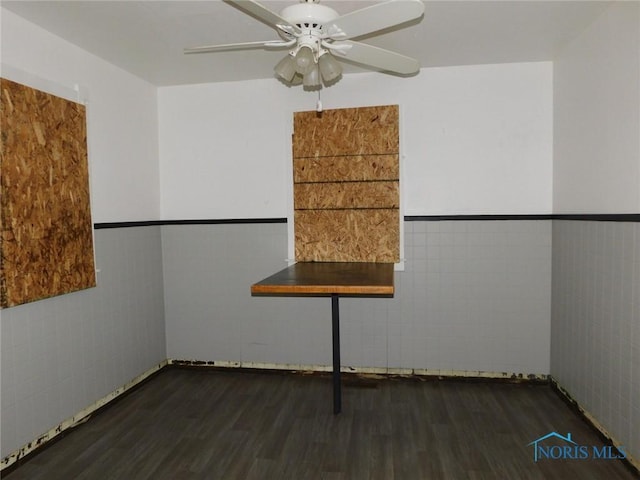 1839 Talbot St, Toledo, OH 43613 - unfurnished room with tile walls, wood finished floors, a ceiling fan, and a wainscoted wall