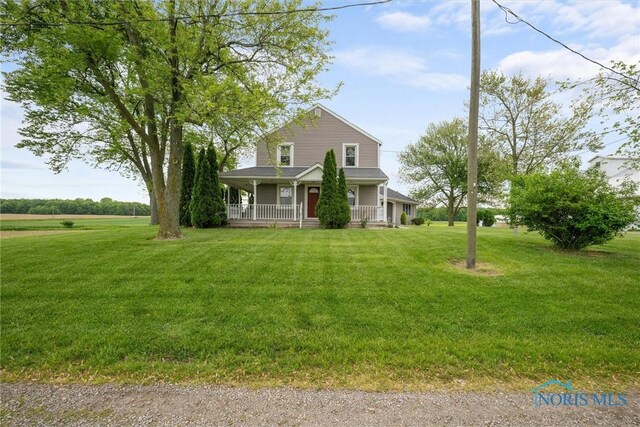 15819 County Road D, Wauseon, OH 43567 - farmhouse featuring a porch and a front lawn