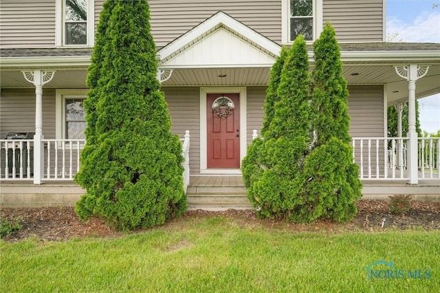15819 County Road D, Wauseon, OH 43567 - view of exterior entry with covered porch and a lawn