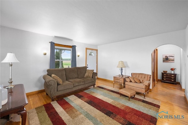 15819 County Road D, Wauseon, OH 43567 - living room with arched walkways, wood finished floors, and baseboards