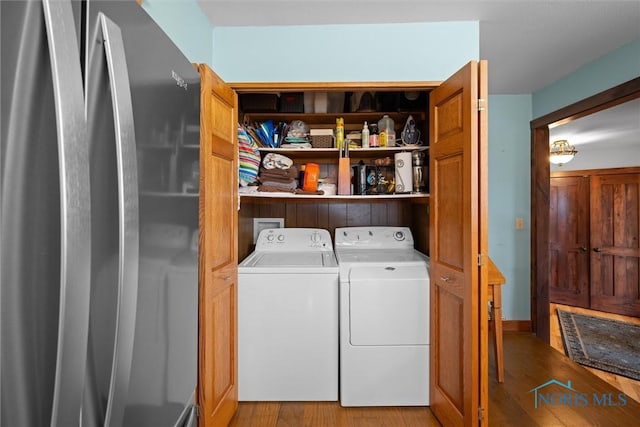 15819 County Road D, Wauseon, OH 43567 - laundry area with washing machine and clothes dryer and wood finished floors