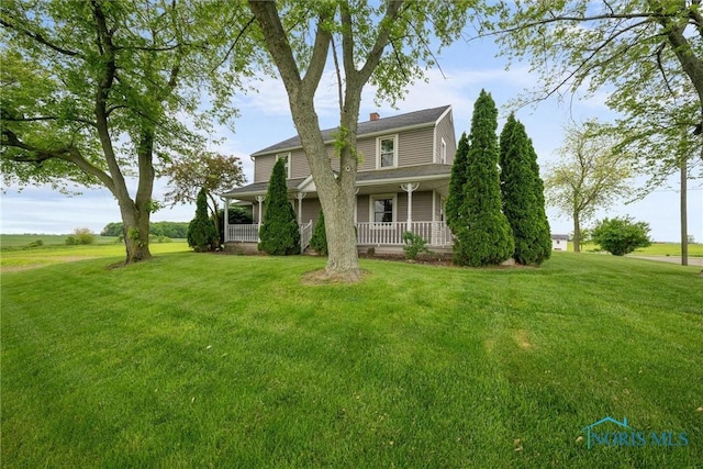 15819 County Road D, Wauseon, OH 43567 - view of front facade with a porch, a front yard, and a chimney