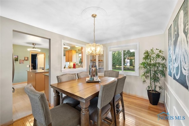 3519 Denise Dr, Toledo, OH 43614 - dining room with a chandelier, light wood-type flooring, and baseboards