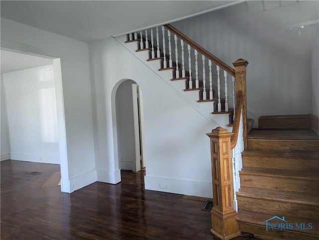 137 N 8th St, Upper Sandusky, OH 43351 - stairs with arched walkways, wood finished floors, and baseboards