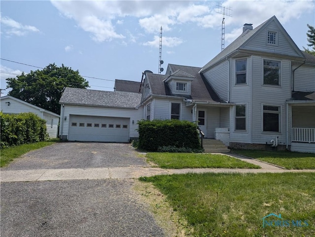 137 N 8th St, Upper Sandusky, OH 43351 - view of front of property featuring driveway, a garage, a front lawn, and roof with shingles