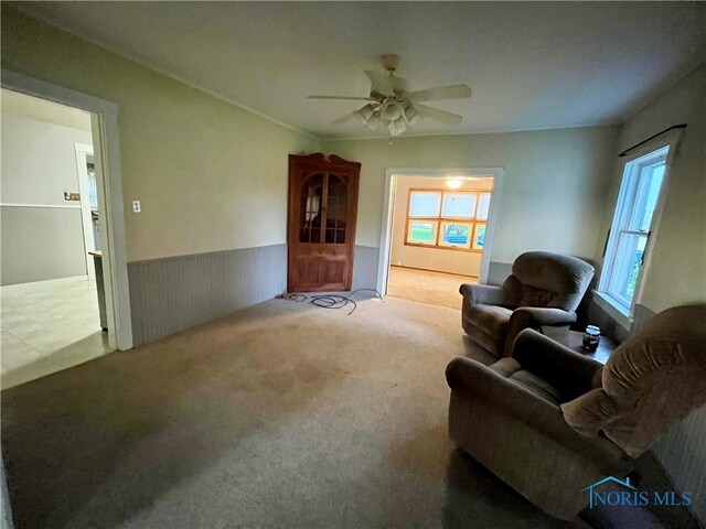 11157 State Route 500, Paulding, OH 45879 - carpeted living area featuring a ceiling fan and wainscoting