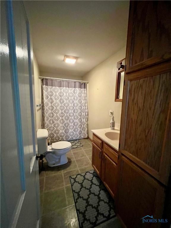 11157 State Route 500, Paulding, OH 45879 - bathroom with vanity, toilet, and a shower with curtain