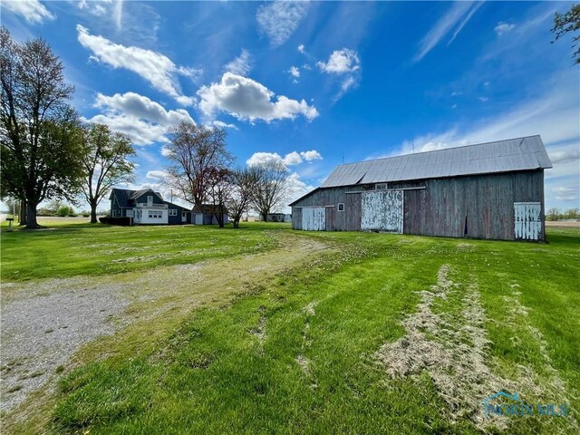 11157 State Route 500, Paulding, OH 45879 - view of green lawn featuring driveway, a barn, and an outdoor structure