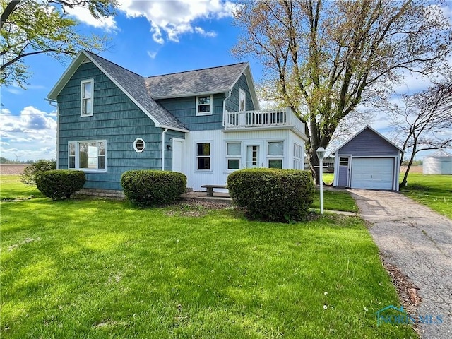 11157 State Route 500, Paulding, OH 45879 - view of front facade with a balcony, a shingled roof, an outdoor structure, a front yard, and a garage
