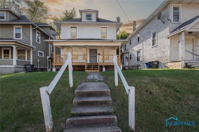 3239 Cherry St, Toledo, OH 43608 - american foursquare style home with a front lawn and a porch